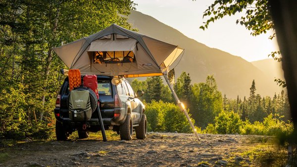 Why is it important to book campsites early in the UK, especially in peak seasons?